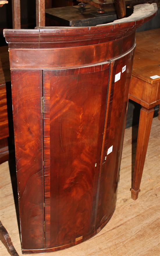 Late George III banded mahogany bow fronted hanging corner cupboard